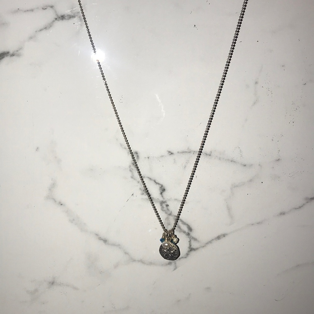 silver sand dollar with blue accent jewels